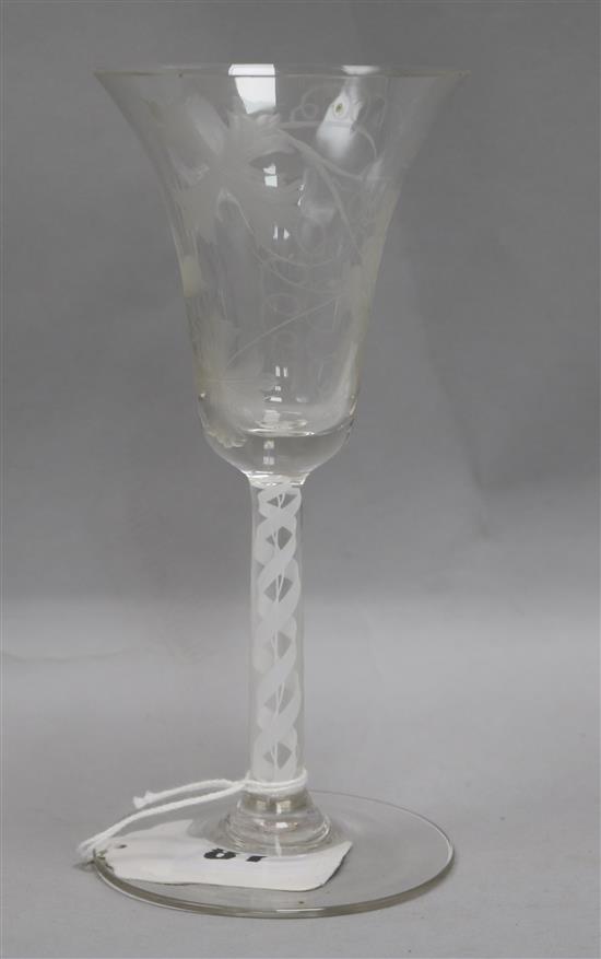 An 18th century wine glass with bell shaped bowl, vine etched bowl and double corkscrew gauze stem